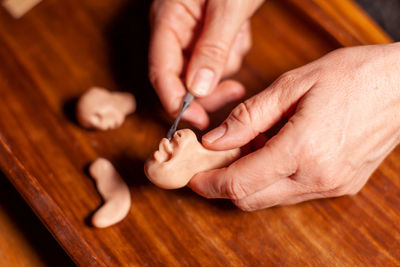 Cropped hands of man working on table