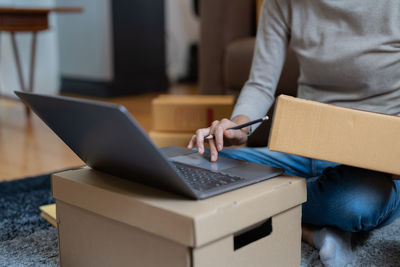 Midsection of woman using laptop