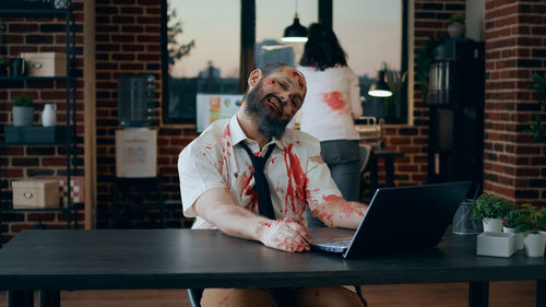 Young man using laptop at table