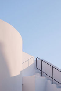 Low angle view of staircase against clear blue sky