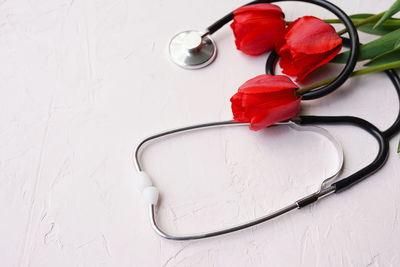 Stethoscope with flowers on white background, medicine doctor's day 