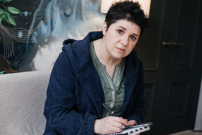 Portrait of young woman sitting outdoors