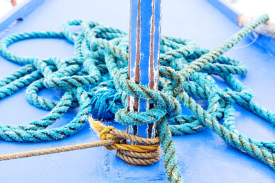 High angle view of rope tied on metal