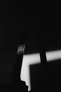 Low angle view of illuminated lighting equipment at night