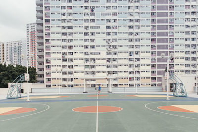 Basketball court against building in city