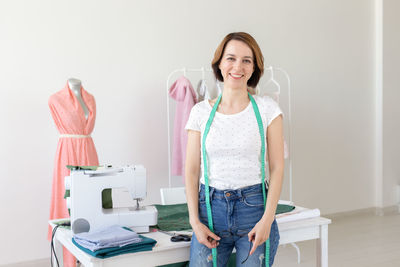 Portrait of smiling young woman standing on table