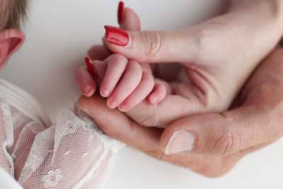 Cropped image of couple holding hands