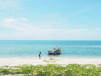 People on beach against sky