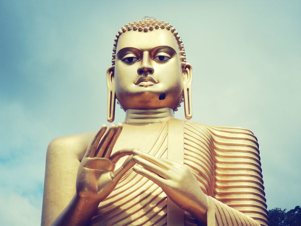 human representation, sculpture, statue, art, art and craft, creativity, religion, spirituality, low angle view, buddha, sky, place of worship, temple - building, close-up, carving - craft product