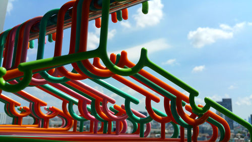 Low angle view of multi colored playground against sky