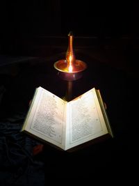 High angle view of illuminated lamp in darkroom