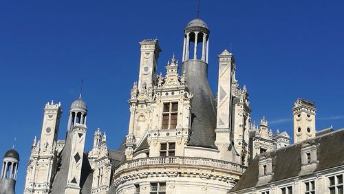 Low angle view of temple against clear blue sky