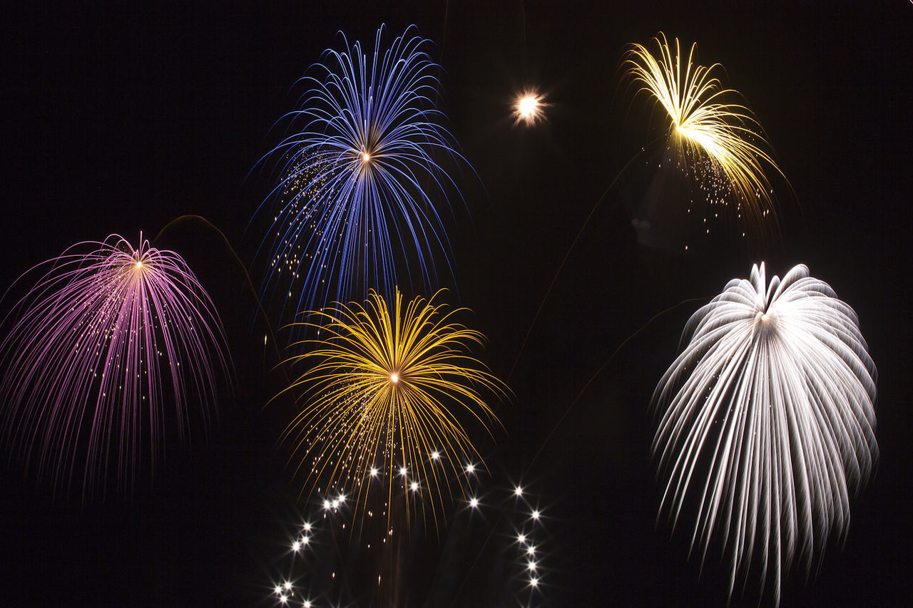 LOW ANGLE VIEW OF FIREWORKS AGAINST SKY AT NIGHT