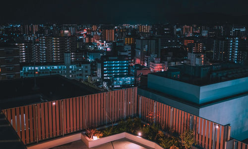 High angle view of illuminated buildings in city at night