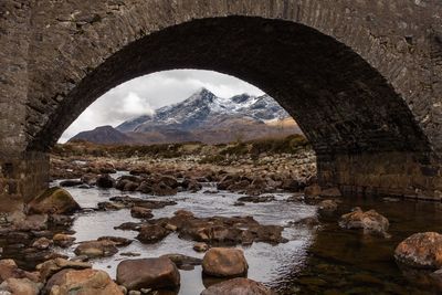 Scenic view of river against cloudy sky