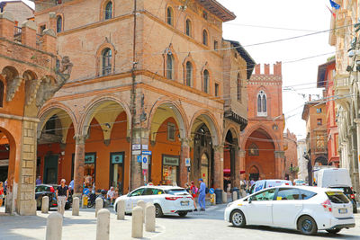 Cars on road amidst buildings in city