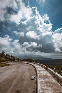 Empty road along countryside landscape