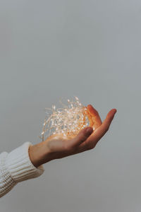 Close-up of person hand against gray background