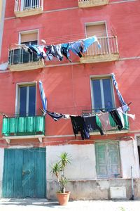 Low angle view of clothes hanging outside building