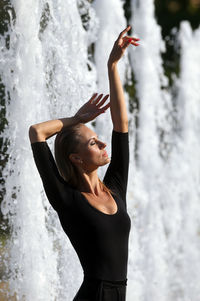 Young woman looking at waterfall