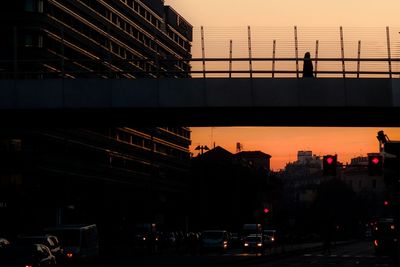 View of bridge in city at sunset