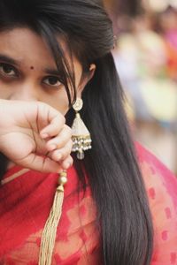 Close-up portrait of young woman wearing jewelry and traditional clothing