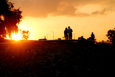 Silhouette of people at sunset