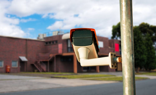 Close-up of laptop on road against sky
