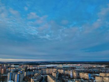 High angle view of buildings and sea against sky