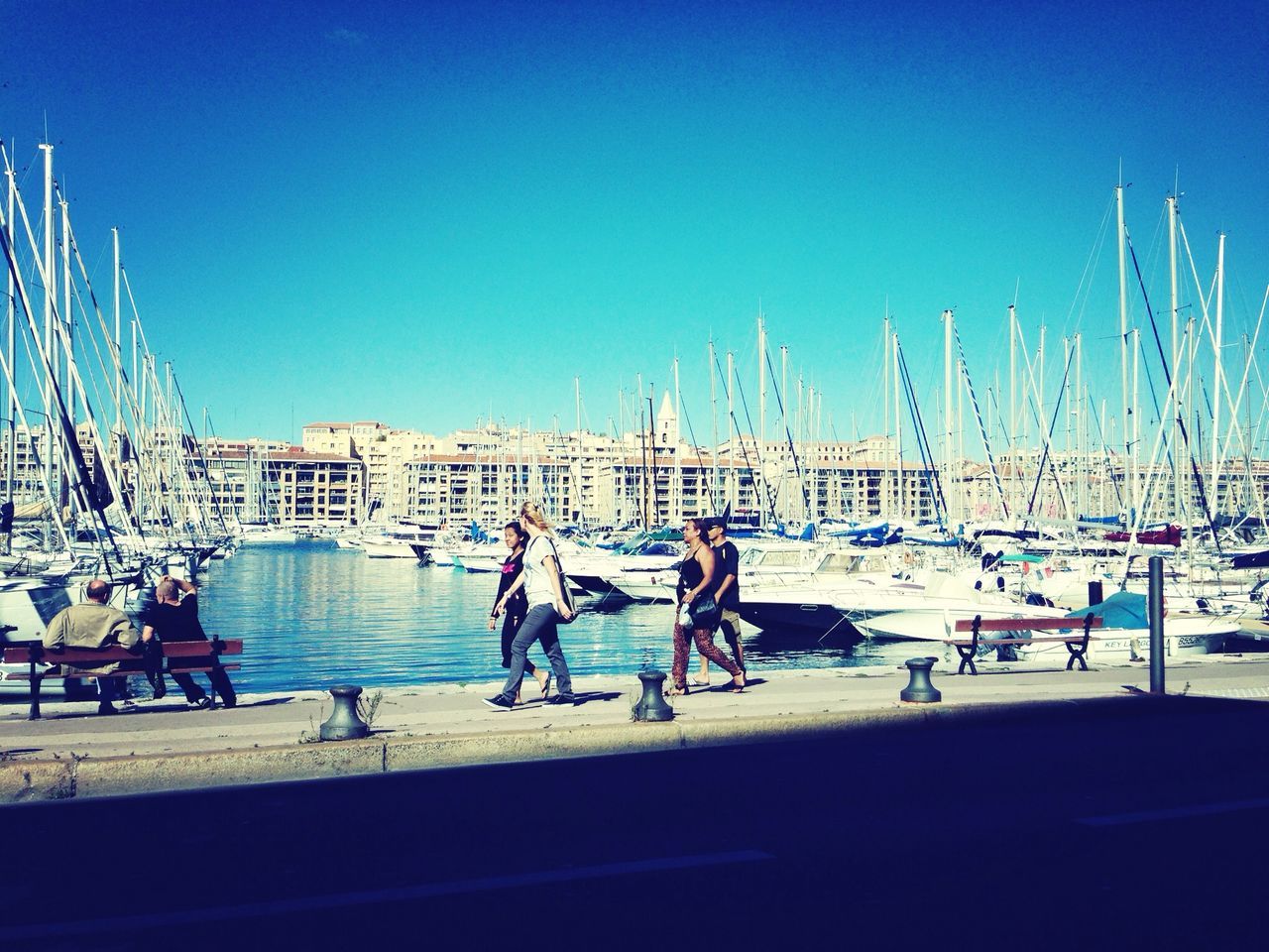 clear sky, blue, copy space, transportation, men, nautical vessel, large group of people, water, lifestyles, leisure activity, mode of transport, person, boat, built structure, harbor, medium group of people, travel, sea, day