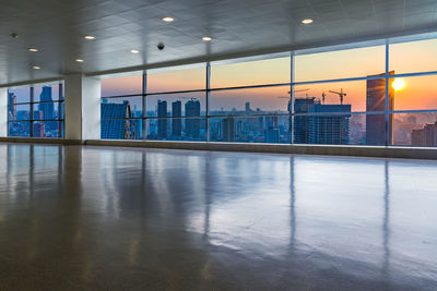 Reflection of illuminated buildings on glass window