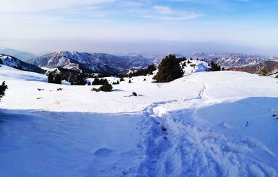 Scenic view of snow mountains against sky