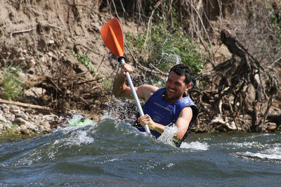 Man kayaking in river