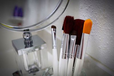 Close-up of make-up brushes on table