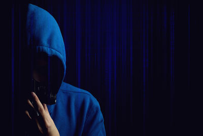 Portrait of person holding blue umbrella