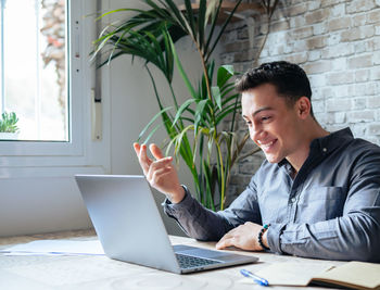 Young man using laptop at office