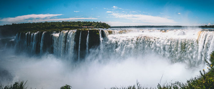 Panoramic view of waterfall against sky