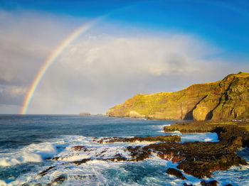 Coastal view and atlantic ocean with rainbow, ponta da ferraria, sao miguel island, azores, portugal