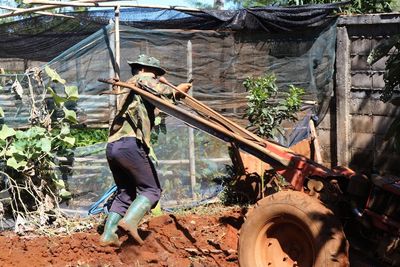 Side view of farmer working in farm