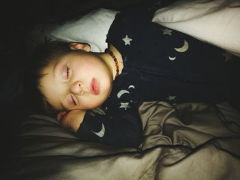 High angle view of baby sleeping on bed