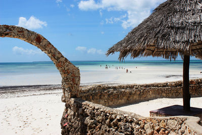 Scenic view of beach against cloudy sky