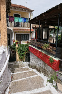 Houses by street against buildings in city