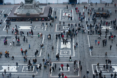 High angle view of people walking on road in city