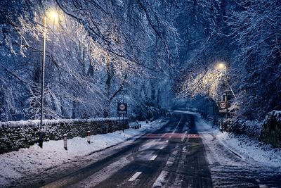 View of snow covered road at night