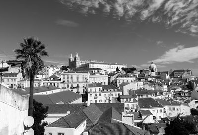 Historic churches in city against sky seen from miradouro de santa luzia