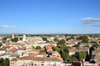 High angle view of town against blue sky