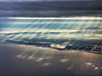 Aerial view of sea and airplane against sky