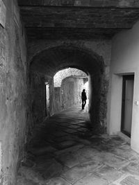 People walking on footpath in tunnel