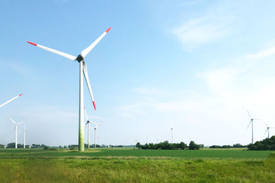 Windmill on field against sky