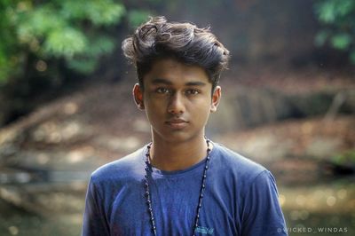 Portrait of young man standing outdoors